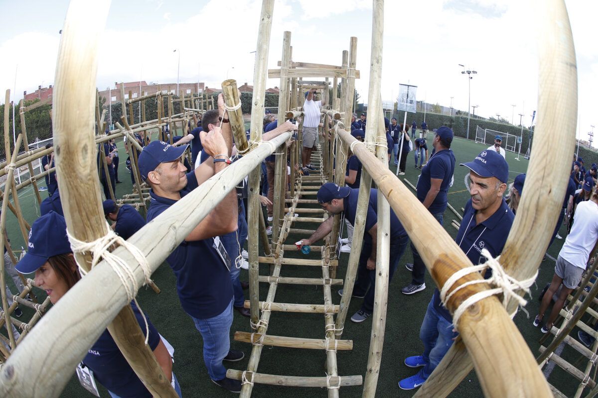 Grupo de personas creando una estructura de puentes en una actividad de team building